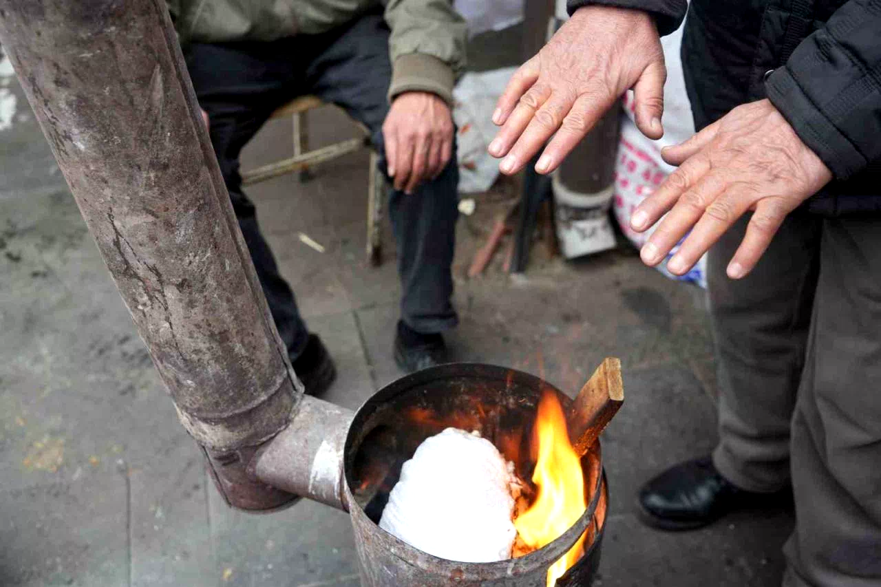 Erzincan pazarcısı soğukta sobayla ısınıyor
