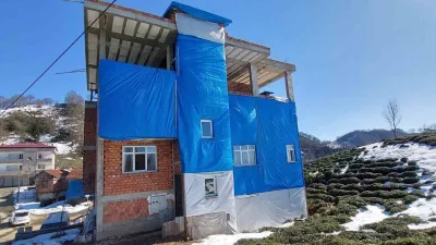 Rize'nin Ayane Köyü'nde yaşayan Mahmut Sandallı, evinin dışını yağmurdan korumak
